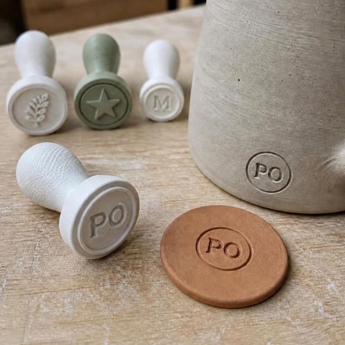 Custom 3D printed maker's mark pottery stamp with PO monogram pressed into clay